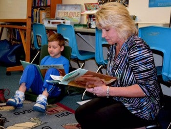 Teacher and student reading puppy mill educational materials