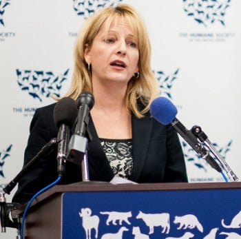 Kathleen Conlee speaking at a podium