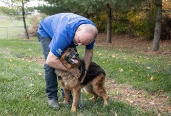 Dog rescued from the dog meat trade, outside with new family