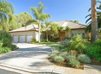 street view of a house with a concrete driveway