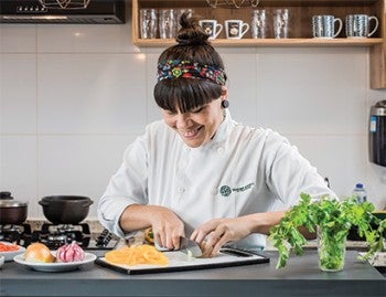 Chef Adriele Carvalho prepares ingredients for her plant-based take on a Brazilian stew.