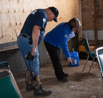 The HSUS Animal Rescue Team and the Indiana Gaming Commission examine the grounds of an alleged cockfighting operation.