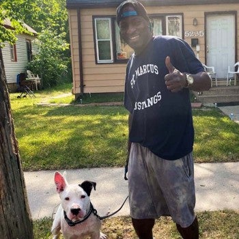 Man with his dog Snowman going for a walk outside