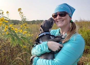 Koda the dog and her owner in a field.