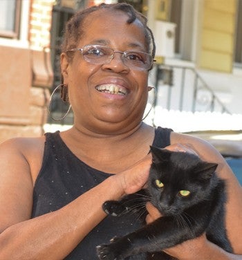 Woman holding a black cat