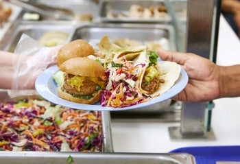 Plant-based food on a plate in a cafeteria. 