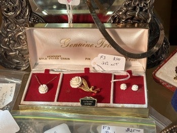 A "Genuine Ivory" labeled pendant, pin, and earrings that sold for $110