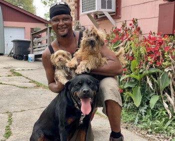 Smiling man with three dogs