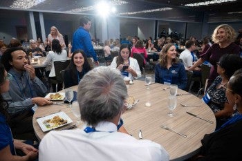 A group of people sitting down at a table