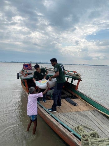 A team distributes flood relief materials