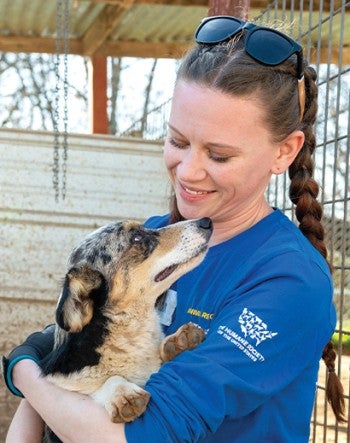 Amanda Wallace holds a corgi at a puppy mill.