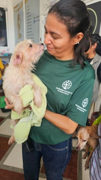 A woman holding a dog