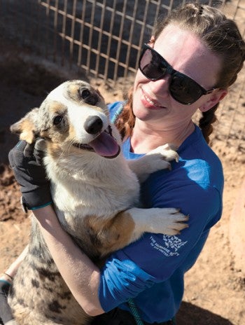 HSUS staff woman. holding a dog at a rescue. 