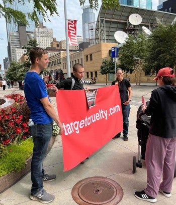 A group of people holding a banner