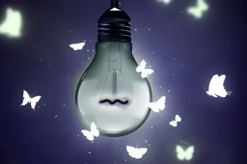 Photo illustration of a dim light bulb with illustrated butterflies