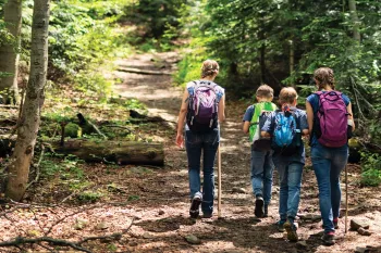 Mother and three kids on a nature walk