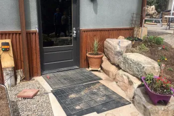 Electric mats on the ground in front of a home's door