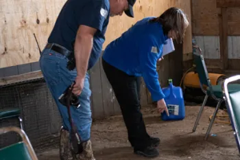 The HSUS Animal Rescue Team and the Indiana Gaming Commission examine the grounds of an alleged cockfighting operation.