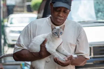 Man holding his white cat