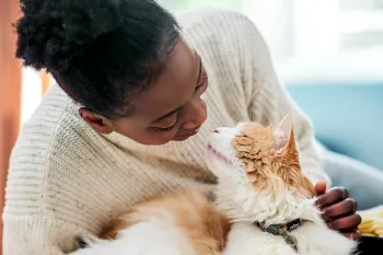 Woman cuddling with her cat