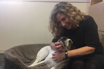 Humane World for Animals CEO Kitty Block cuddles with a dog.