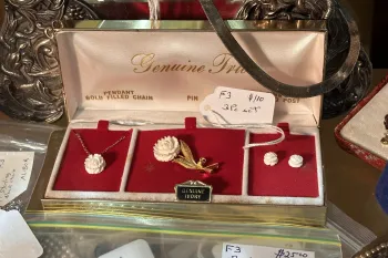 A "Genuine Ivory" labeled pendant, pin, and earrings that sold for $110