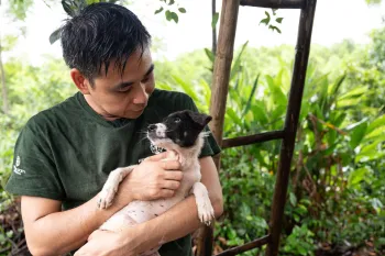 A man holding a dog