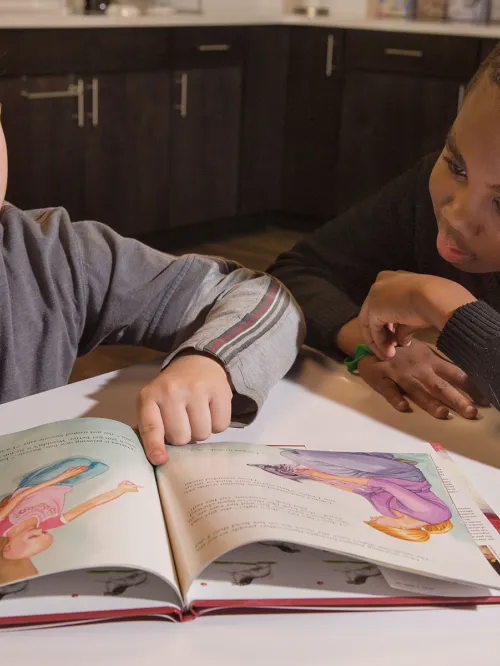 Boys reading puppy mill education materials