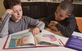 Boys reading puppy mill education materials