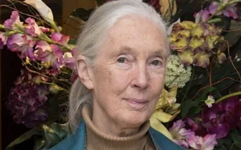 Jane Goodall standing in front of a floral arrangement